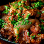 Close up lamb bhuna curry served in an iron karahi.