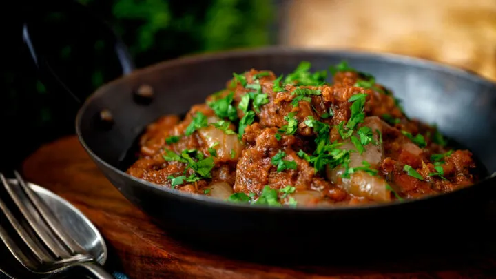 British Indian restaurant inspired lamb bhuna curry served in an iron karahi.