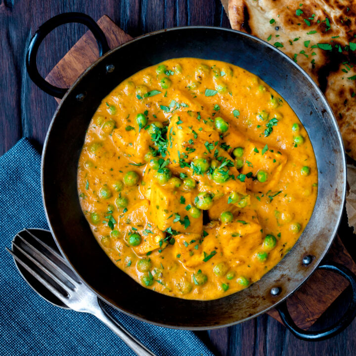 Matar paneer curry or mutter paneer served in an iron kadai.