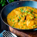 Matar paneer curry served in an iron kadai with fresh coriander featuring a title overlay.