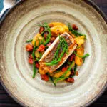 overhead pan fried hake with chorizo, new potatoes and samphire.