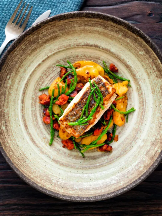 overhead pan fried hake with chorizo, new potatoes and samphire.