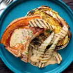 Overhead pork chops with pears and a cider tarragon sauce served with roasted cabbage.