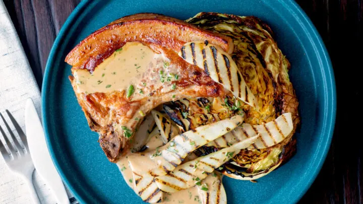 Pork chops with griddled pears and cider tarragon sauce served with roasted cabbage.