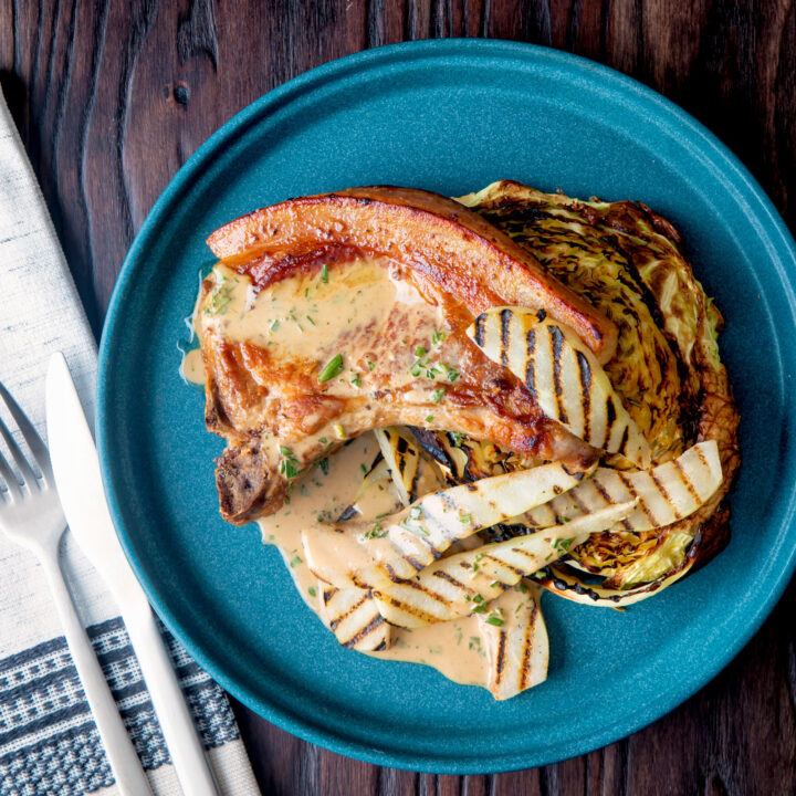 Pork chops with griddled pears and cider tarragon sauce served with roasted cabbage.