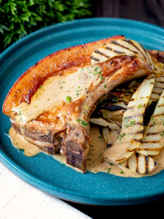 Close up pork chops with griddled pears and cider tarragon sauce.