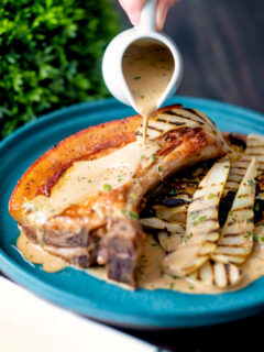 Creamy cider tarragon sauce poured over pork chops with griddled pears.