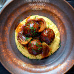 Overhead pork meatballs in a beer BBQ sauce served on cheesy polenta featuring a title overlay.