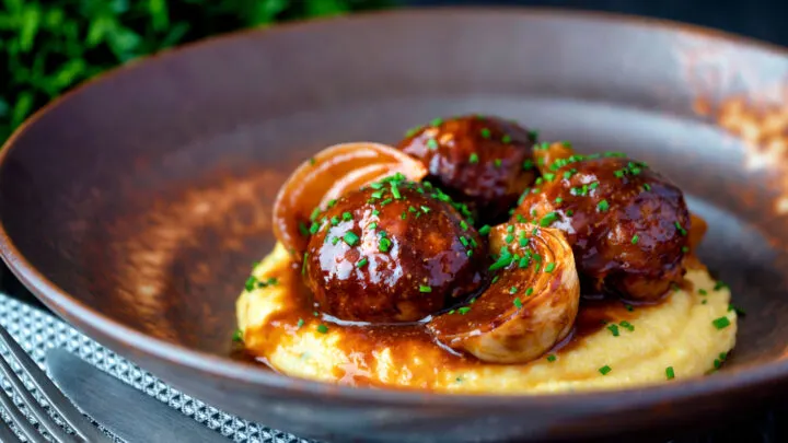 Pork meatballs with onion wedges in a beer BBQ sauce served on cheesy polenta.