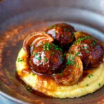 Pork meatballs in a beer BBQ sauce served on cheesy polenta.