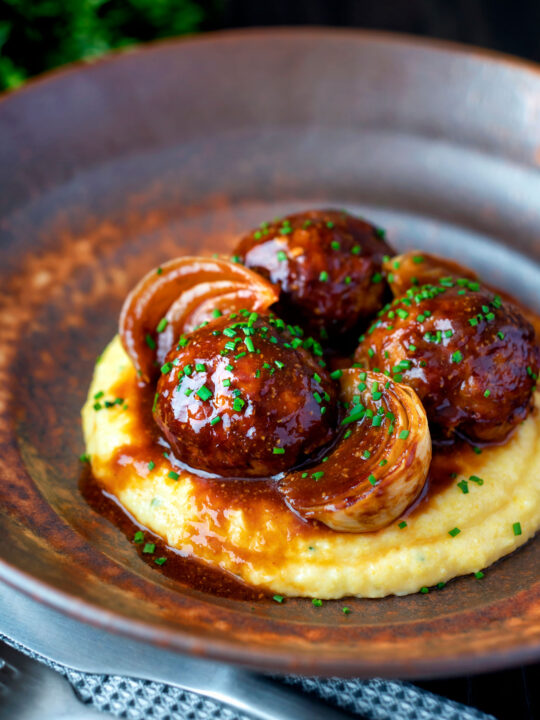 Pork meatballs in a beer BBQ sauce served on cheesy polenta.