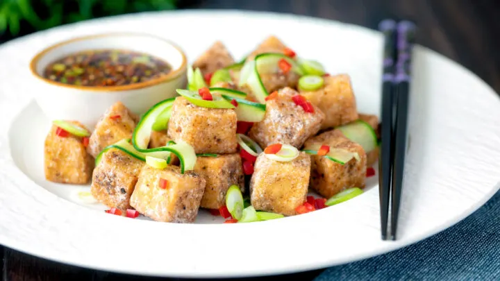 Salt and pepper tofu with a chilli soy dipping sauce, spring onions and pickled cucumber.