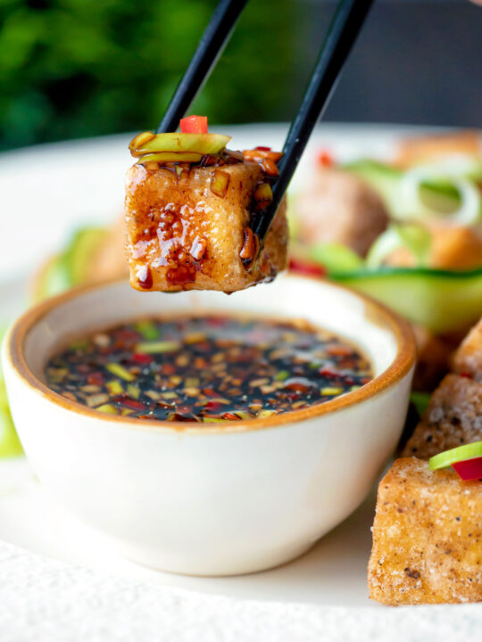 Salt and pepper tofu dipped into a soy and chilli dipping sauce.
