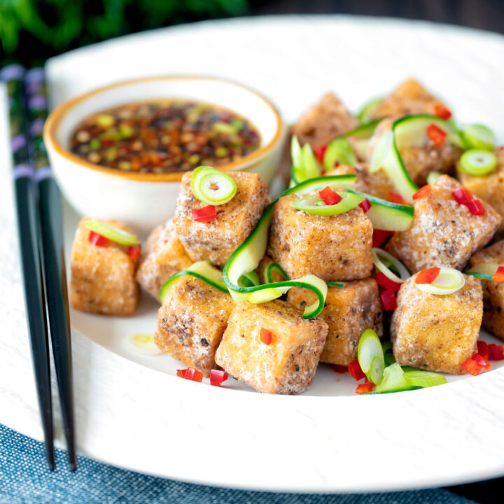 Salt and pepper tofu with a chilli soy dipping sauce, spring onions and pickled cucumber.
