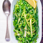 Overhead samphire salad with peas, broad beans and shaved asparagus featuring a title overlay.