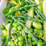 Close up samphire salad with peas, broad beans and shaved asparagus.
