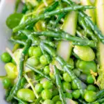 Close up samphire salad with peas, broad beans and shaved asparagus featuring a title overlay.