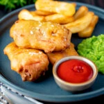 Crispy spam fritters served with chips, mushy peas and ketchup.