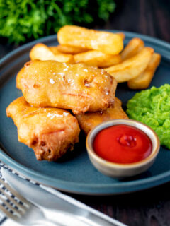 Crispy spam fritters served with chips, mushy peas and ketchup.