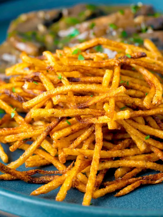 Close up crispy fried straw or matchstick potatoes.