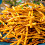 Close up crispy fried straw or matchstick potatoes featuring a title overlay.