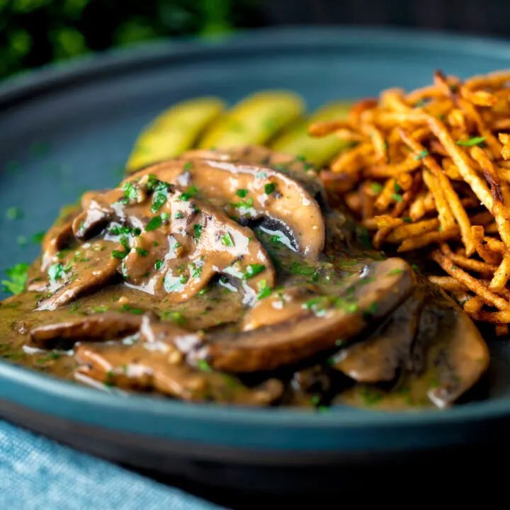 Easy vegan mushroom stroganoff served with pickles and straw potatoes.