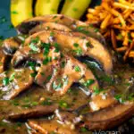 Close up vegan mushroom stroganoff served with pickles featuring a title overlay.