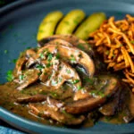Vegan mushroom stroganoff served with pickles.
