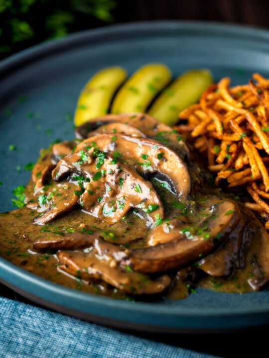 Vegan mushroom stroganoff served with pickles.