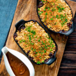 Overhead root vegetable crumble with an oaty crumb with a vegan onion gravy.