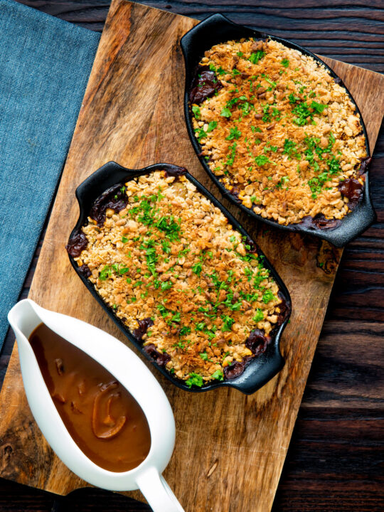 Overhead root vegetable crumble with an oaty crumb with a vegan onion gravy.