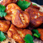 Close up Amritsari fish pakora served with chapatis and coriander.