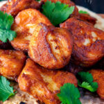 Close up Amritsari fish pakora served with chapatis and coriander featuring a title overlay.