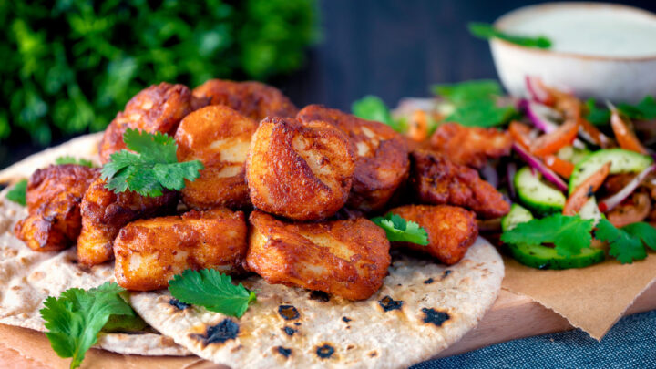 Amritsari fish pakora served with chapatis, kachumber salad, mint raita and fresh coriander.