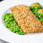 Baked cod loin in crispy panko breadcrumbs with crushed minted peas and potatoes.