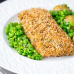 Baked cod loin in crispy panko breadcrumbs with crushed minted peas and potatoes.