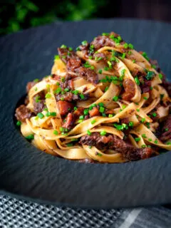 Beef cheek ragu served with pappardelle pasta and snipped chives.