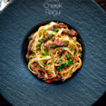 Overhead beef cheek ragu served with pappardelle pasta and snipped chives featuring a title overlay.