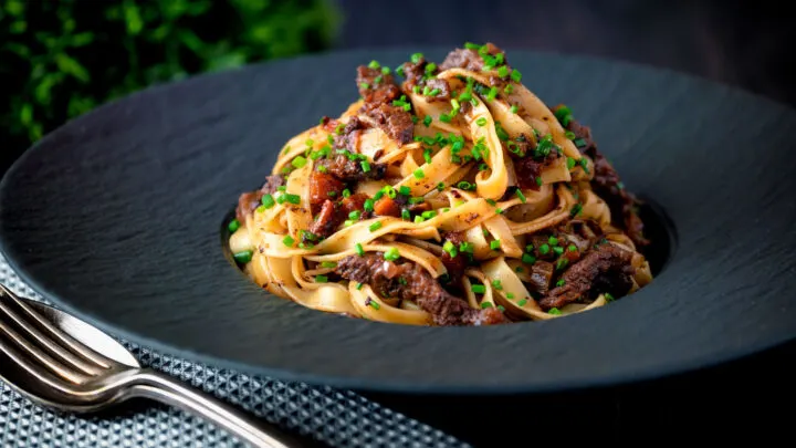 Slow cooked beef or ox cheek ragu served with pappardelle pasta and snipped chives.