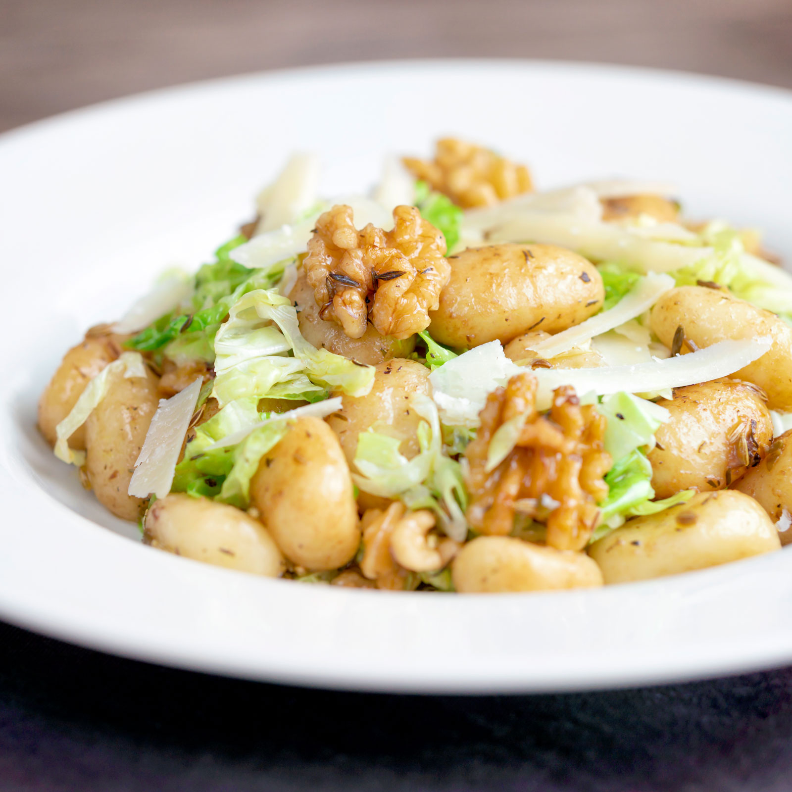 Cabbage gnocchi with fennel seeds and balsamic vinegar served with parmesan shavings.