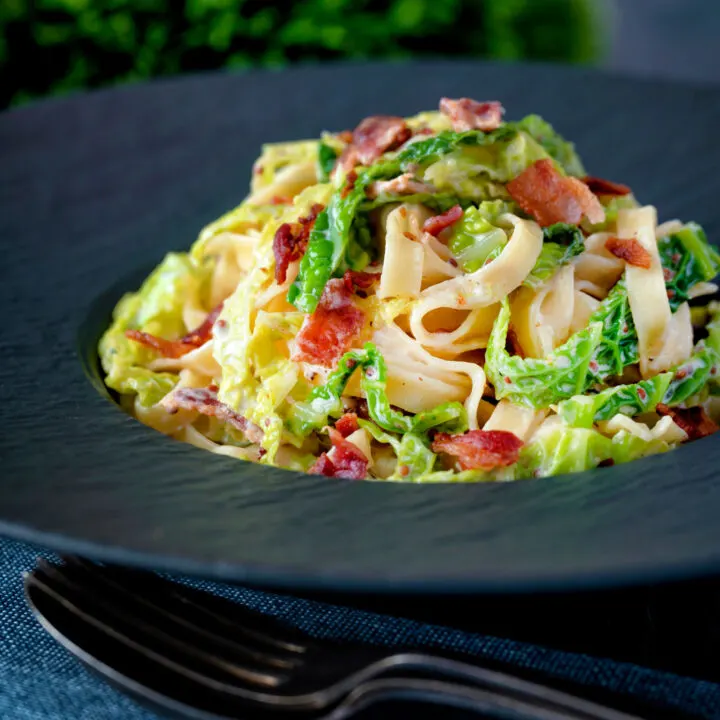 Creamy savoy cabbage pasta with crispy bacon, sour cream and mustard.