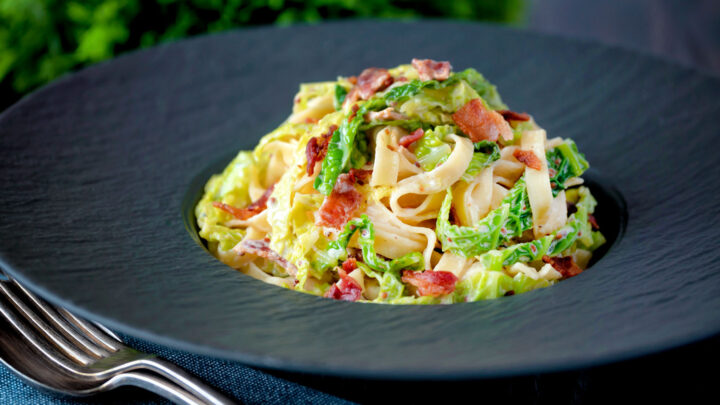 Creamy savoy cabbage pasta with crispy bacon, sour cream and mustard.