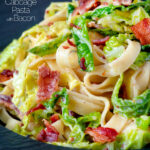 Close up creamy savoy cabbage pasta with crispy bacon and sour cream featuring a title overlay.