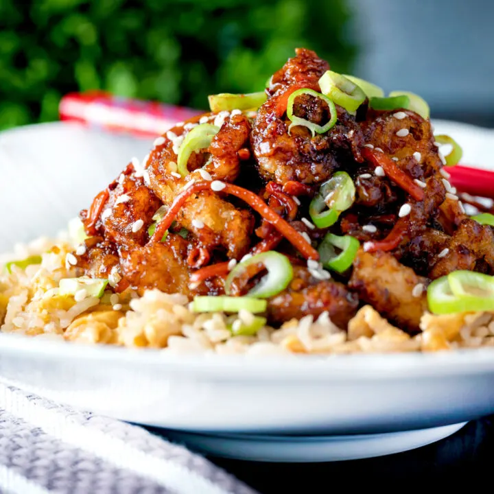 Chinese takeaway style spicy and crispy orange chicken with egg fried rice.