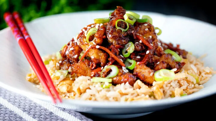 Chinese takeaway style spicy and crispy orange chicken with egg fried rice.