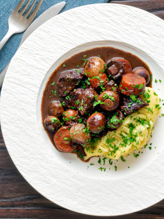 Overhead Instant Pot beef bourguignon or burgundy served with mashed potatoes.