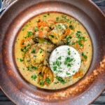 Overhead South Indian influenced monkfish curry with coconut milk.