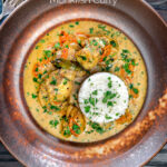 Overhead South Indian influenced monkfish curry with coconut milk featuring a title overlay.