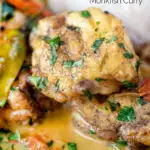 Close up South Indian influenced monkfish curry with coconut milk featuring a title overlay.