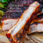 Close up oven baked sticky BBQ pork ribs featuring a title overlay.